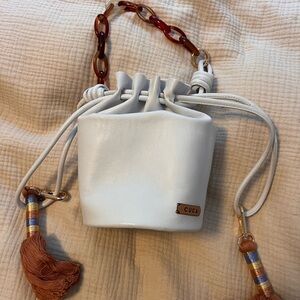 White Mini Drawstring Bag with Tortoiseshell Chain